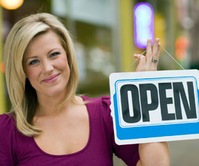 Woman holding Open Sign
